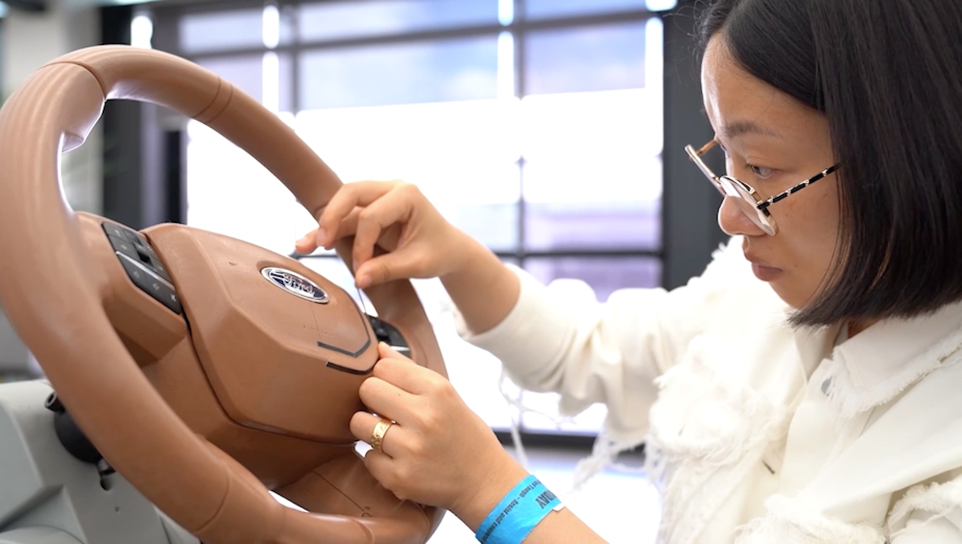 Ford interior designer, Anqi Lee, applying detail to a clay steering wheel.